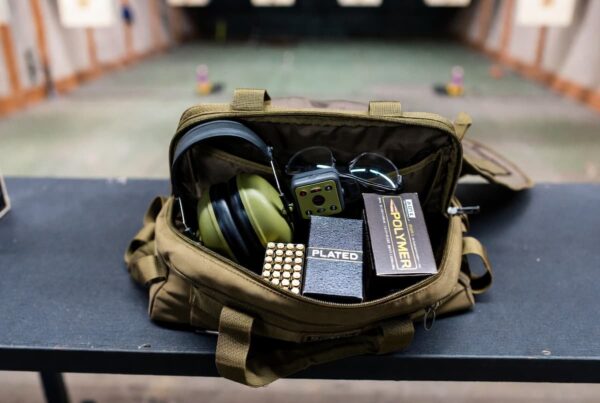 A shooting bag containing boxes of plated and polymer-coated ammunition, for comparing polymer coated bullets vs plated.