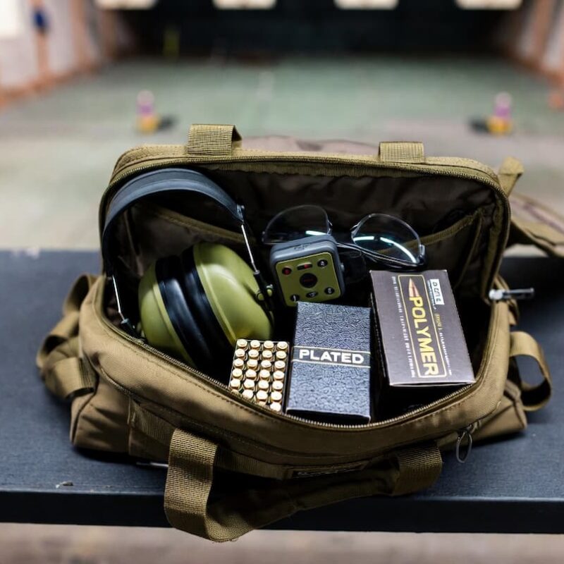 A shooting bag containing boxes of plated and polymer-coated ammunition, for comparing polymer coated bullets vs plated.