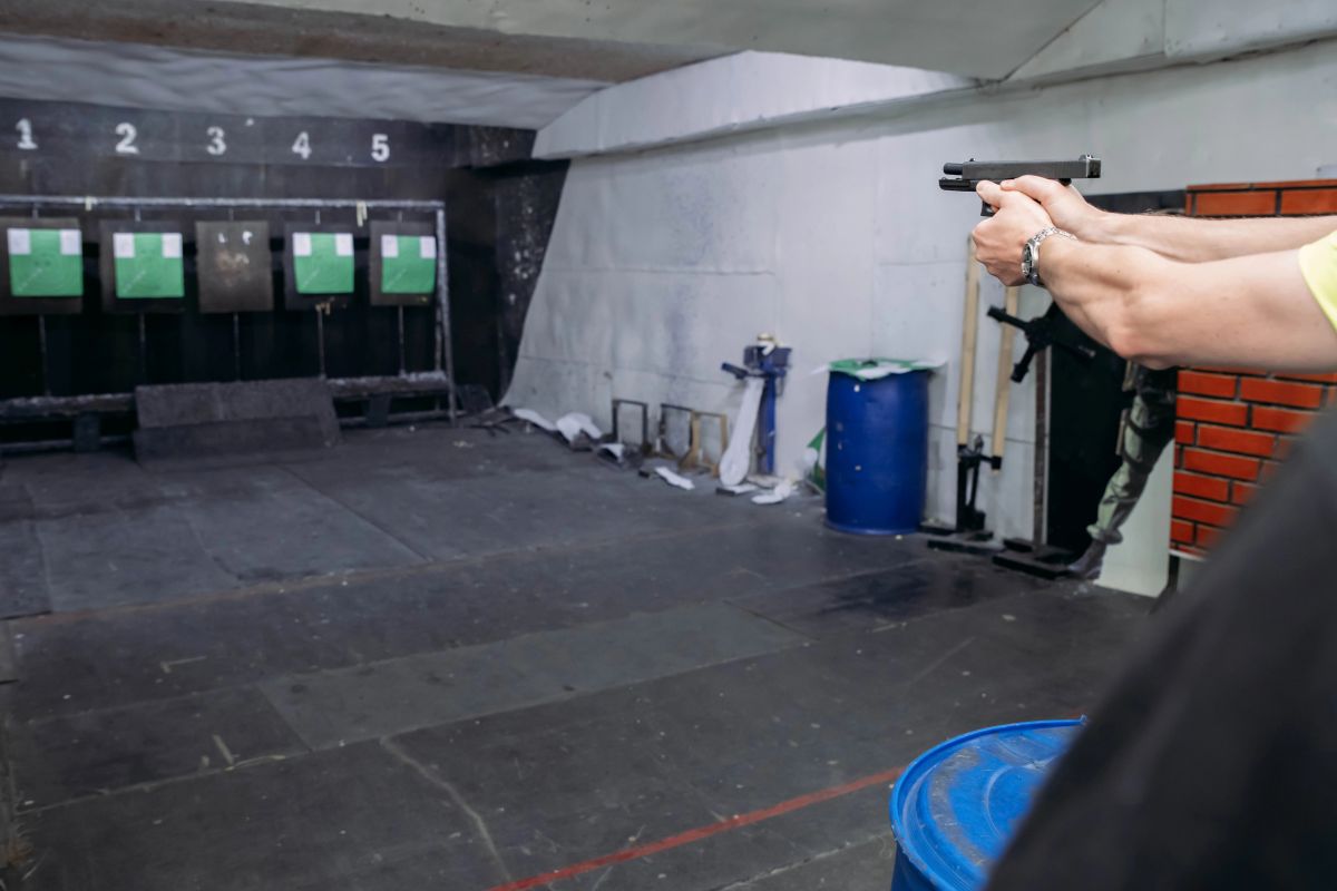 A shooter at an indoor firing lane testing if blue bullets are good for indoor shooting for better visibility and air.