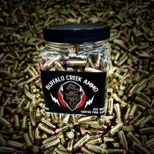 Plastic jar of Buffalo Creek 9mm 124 grain FMJ bullets for range training, surrounded by loose ammunition.
