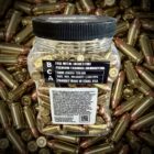 Back view from Plastic jar of Buffalo Creek 9mm 124 grain FMJ bullets for range training, surrounded by loose ammunition.