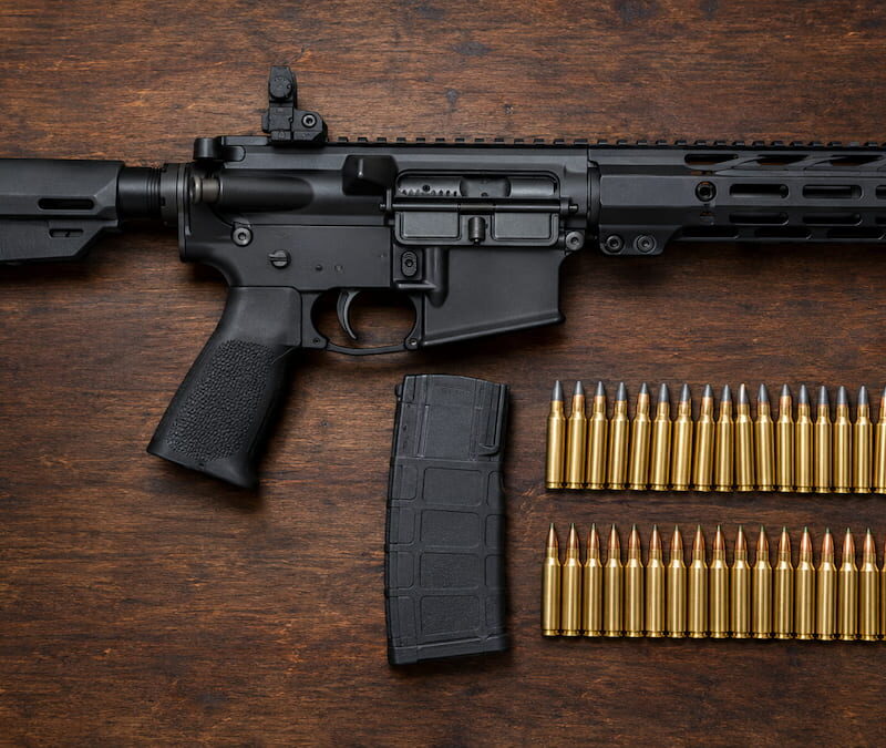 AR-15 SBR with 5.56 cartridges on a workbench, showing the best ammo for 10.5 barrels for top performance.